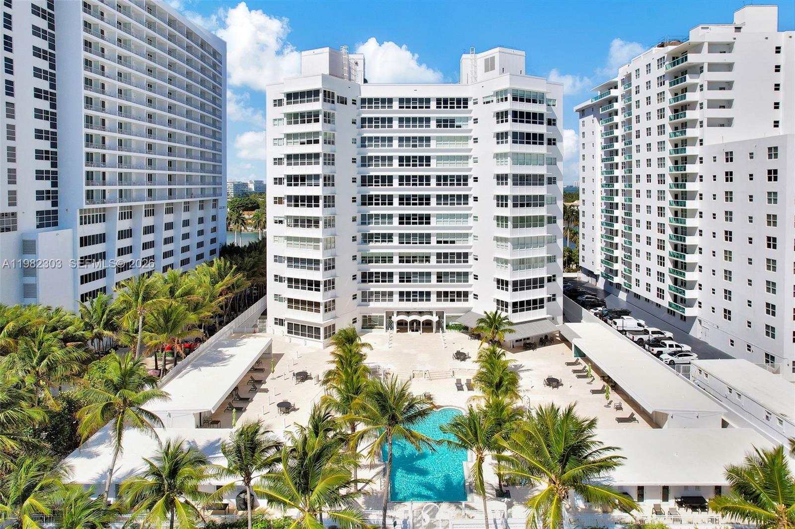 An aerial view of a white high-rise residential building with a central swimming pool — 4925 Collins Ave # 4A, Miami Beach FL 33140, MIAMI BEACH, FL