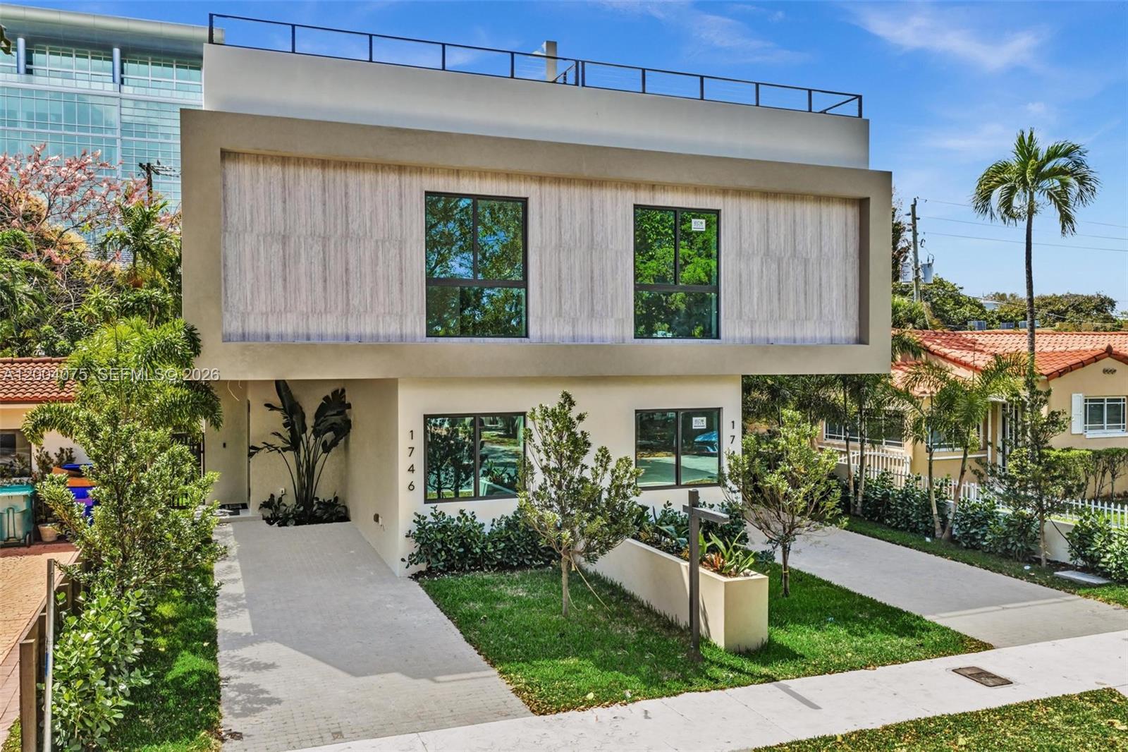 A modern two-story house with a flat roof, light-colored facade, and a paved driveway — 1748 SW 21st Ter, Miami FL 33145, MIAMI, FL