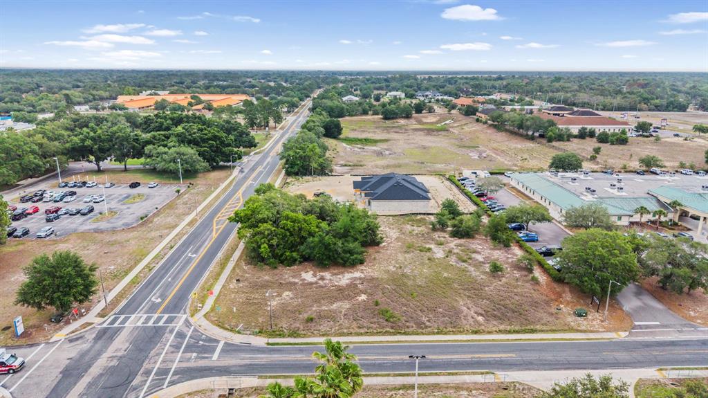 An aerial view shows a vacant lot with a single house under construction near roads — 00 QUALITY DRIVE, SPRING HILL, FL