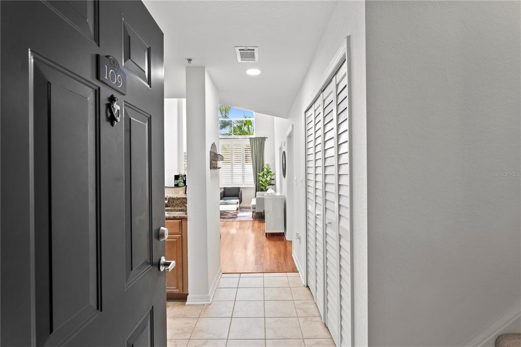 An open front door reveals a tiled entryway leading into a living area with hardwood floors — 700 S HARBOUR ISLAND BOULEVARD UNIT 109, TAMPA, FL