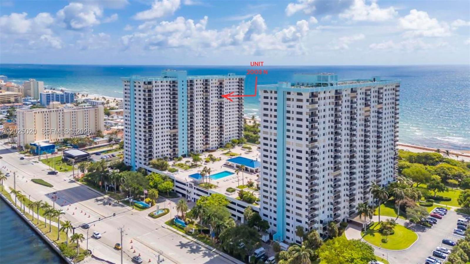 An aerial view shows two tall residential buildings situated along a beach with an oceanfront — 1201 S Ocean Dr # 2003N, Hollywood FL 33019, HOLLYWOOD, FL