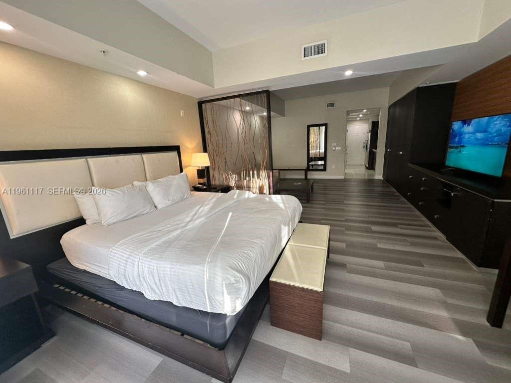A modern bathroom features a double vanity, a large mirror, and a glass-enclosed shower — 5300 NW 87th Ave # 910, Doral FL 33178, DORAL, FL