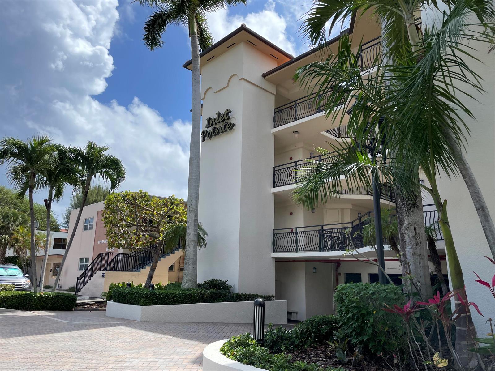 A multi-story building with a sign reading Inlet Pointe features balconies and palm trees — 314 Inlet Way # 201, Palm Beach Shores FL 33404, PALM BEACH SHORES, FL