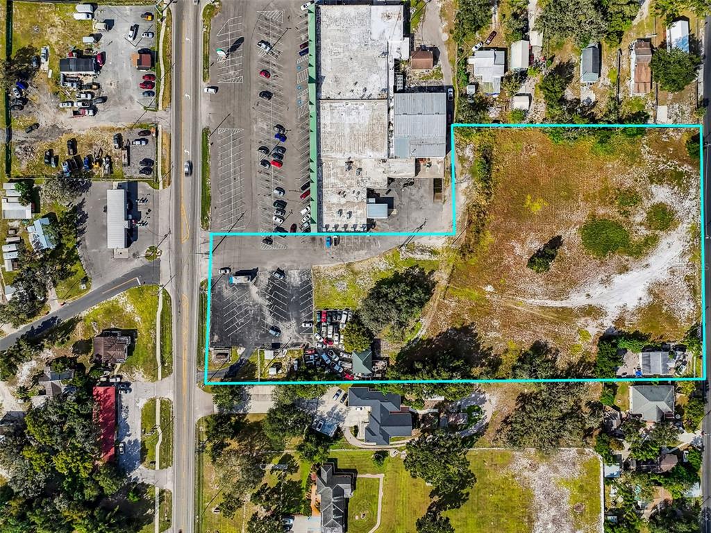 An aerial view shows a commercial building and an adjacent vacant lot outlined in blue — 3309 GLORIA AVENUE, PLANT CITY, FL