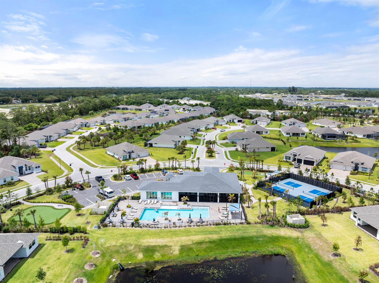 An aerial view of a residential community featuring a clubhouse, swimming pool, and tennis courts — 6390 High Pointe West Way, Vero Beach FL 32967, VERO BEACH, FL