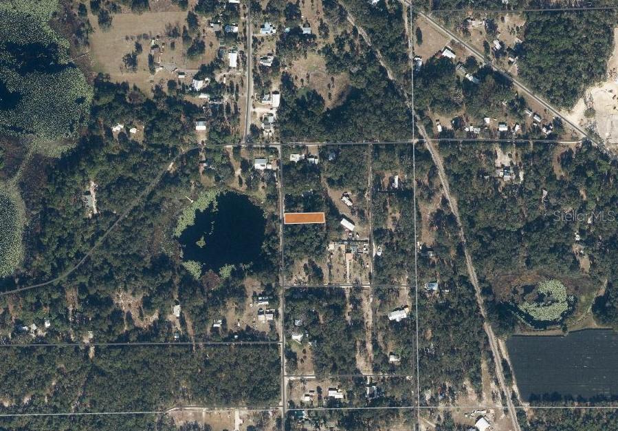 An aerial view shows a rectangular property lot highlighted in orange within a wooded area — 436 HUNTINGTON SHORTCUT ROAD, POMONA PARK, FL