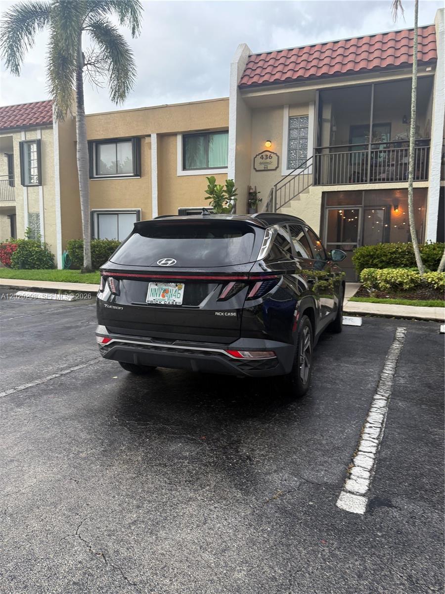 A black Hyundai Tucson is parked in front of a two-story tan apartment building — 436 Lakeview Dr # 203, Weston FL 33326, WESTON, FL