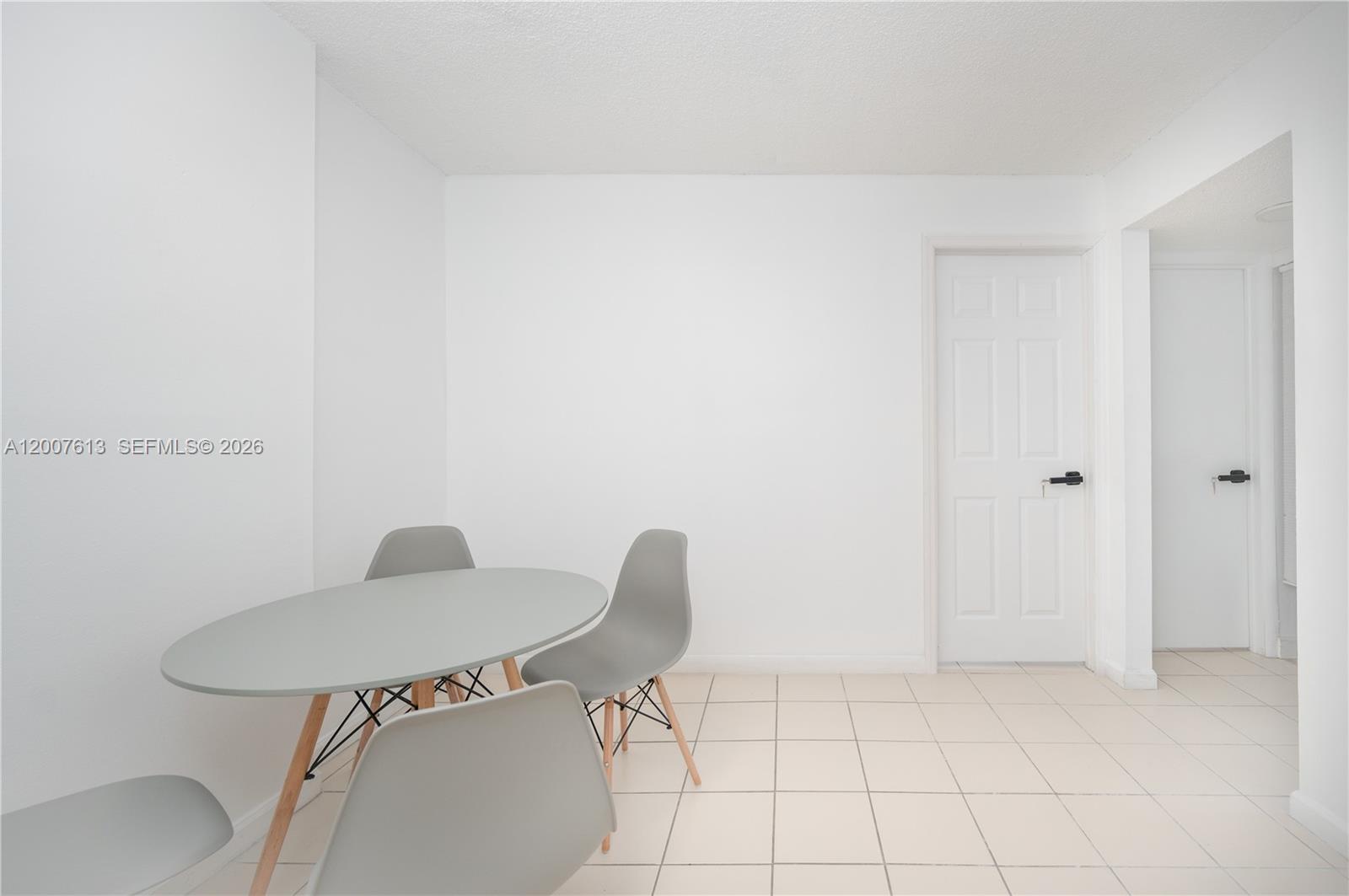 A dining area features a grey oval table, four grey chairs, and white tiled floors — 500 NE 26th St # 2C, Miami FL 33137, MIAMI, FL