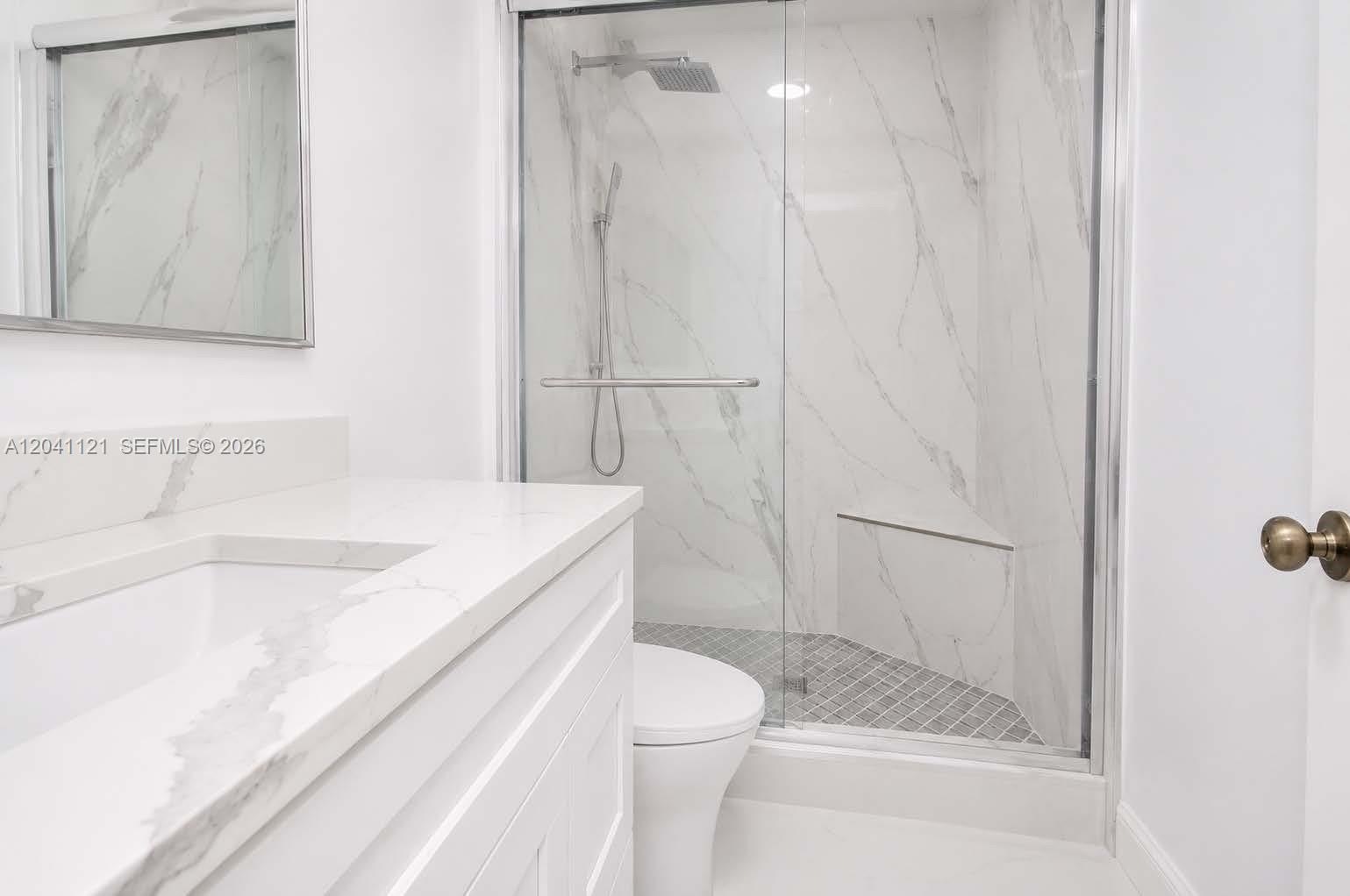 A bathroom features a white vanity with a marble countertop and a glass-enclosed shower — 13127 SW 44th St # 12202, Miramar FL 33027, MIRAMAR, FL