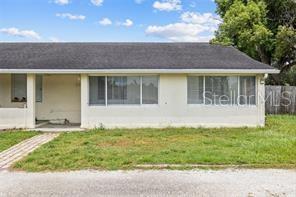 A single-story house with a dark shingled roof and light-colored exterior walls — 2196 BELL CHEER DRIVE, CLEARWATER, FL