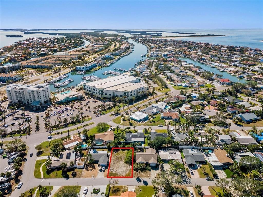 An aerial view shows a vacant rectangular lot outlined in red within a residential neighborhood — 164 2ND STREET W, ST PETERSBURG, FL