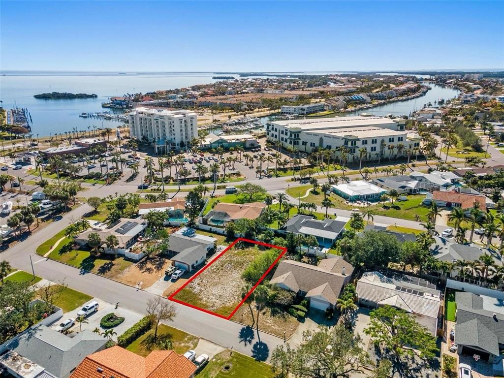 An aerial view shows a vacant rectangular lot outlined in red within a residential neighborhood — 164 2ND STREET W, ST PETERSBURG, FL