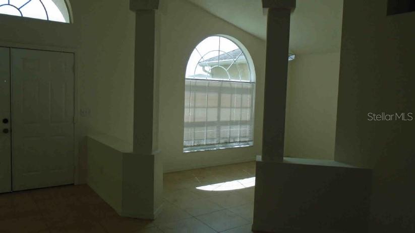 An interior view shows a room with tiled floors, arched windows, and decorative columns — 3142 ATWATER DRIVE, ORLANDO, FL