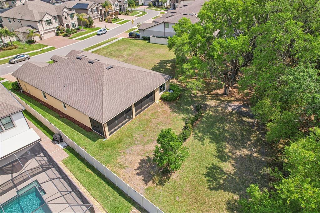 An aerial view shows a house with a screened-in patio and a large grassy yard — 19246 BRIARBROOK DRIVE, TAMPA, FL