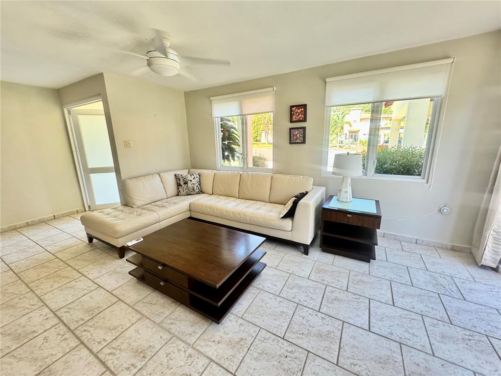 A living room features a white sectional sofa, a tiered wooden coffee table, and tile flooring — C4 AURORA UNIT C-4, HUMACAO, PR