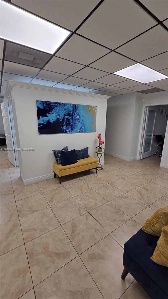 A waiting area features a yellow bench, abstract wall art, and tiled flooring — 12001 SW 128th Ct # 101, Miami FL 33186, MIAMI, FL