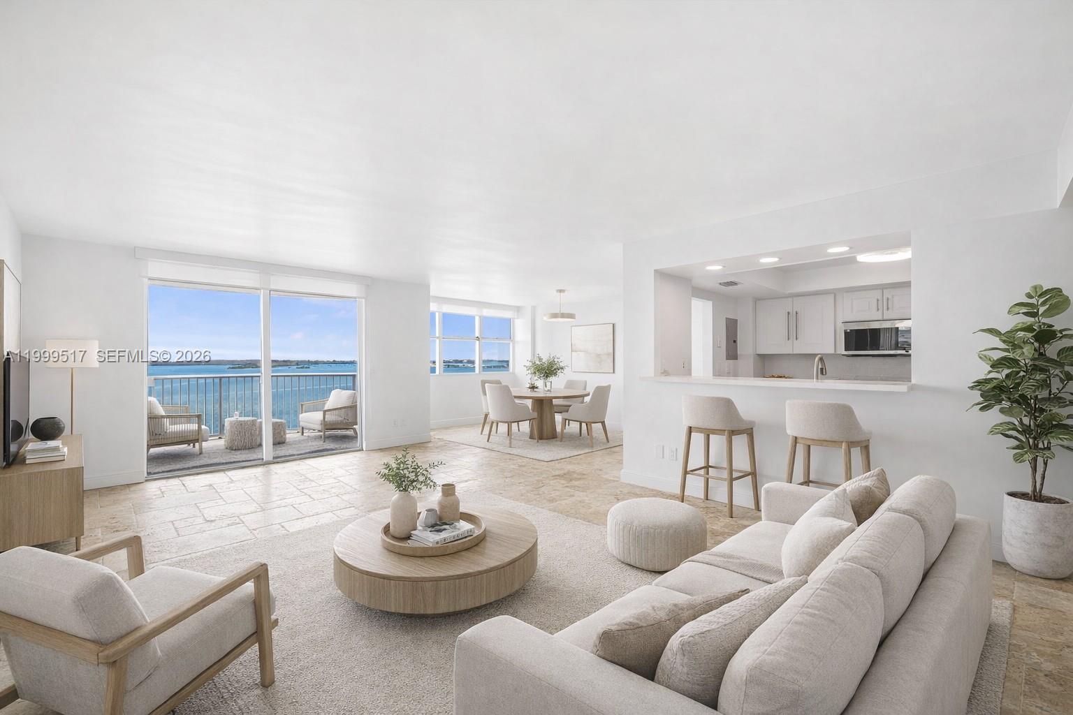 A bright, open-concept living and dining area features tile floors, neutral furniture, and a balcony view — 1420 Brickell Bay Dr # 1401A, Miami FL 33131, MIAMI, FL