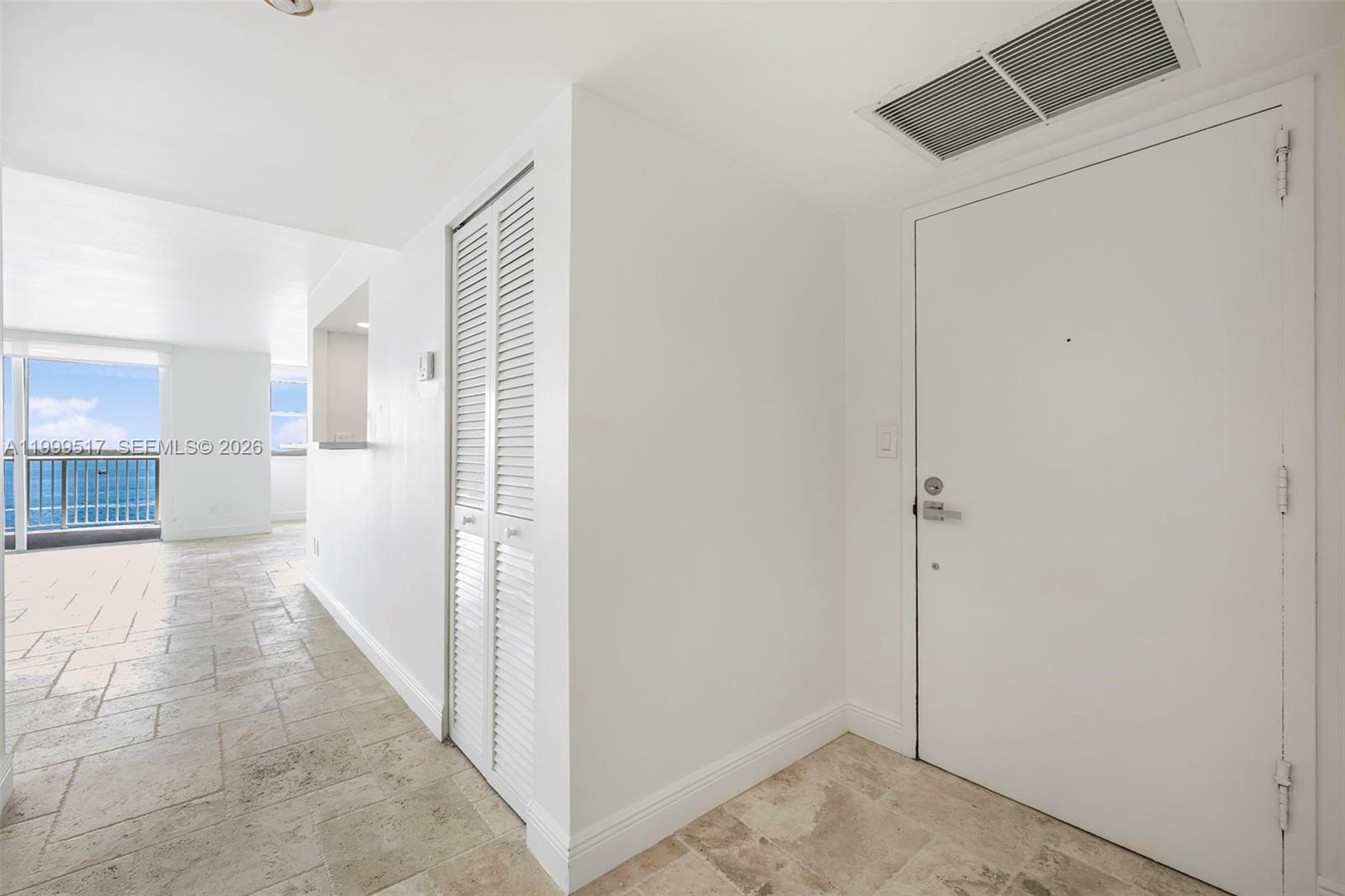 An entryway with tile flooring leads to a living area featuring a view of the ocean — 1420 Brickell Bay Dr # 1401A, Miami FL 33131, MIAMI, FL