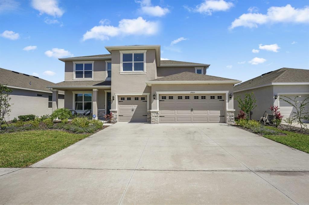 A two-story suburban house with a three-car garage and a concrete driveway — 17925 FATTORIA TERRACE, LAKEWOOD RANCH, FL