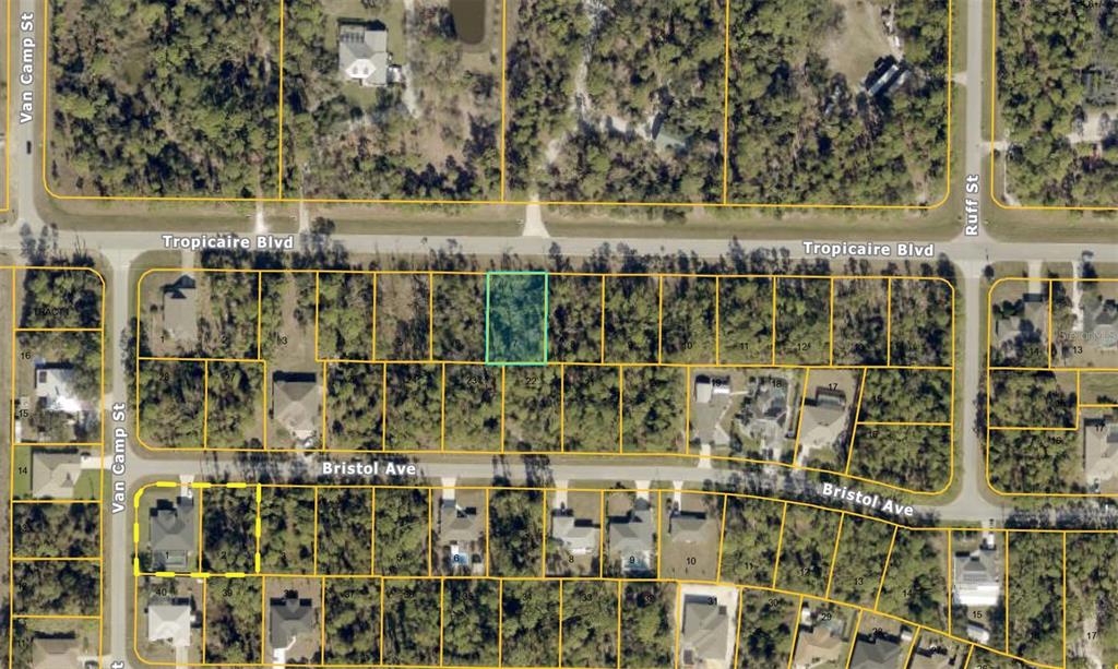 This is an aerial map showing a highlighted vacant residential lot among surrounding properties — TROPICAIRE BOULEVARD, NORTH PORT, FL