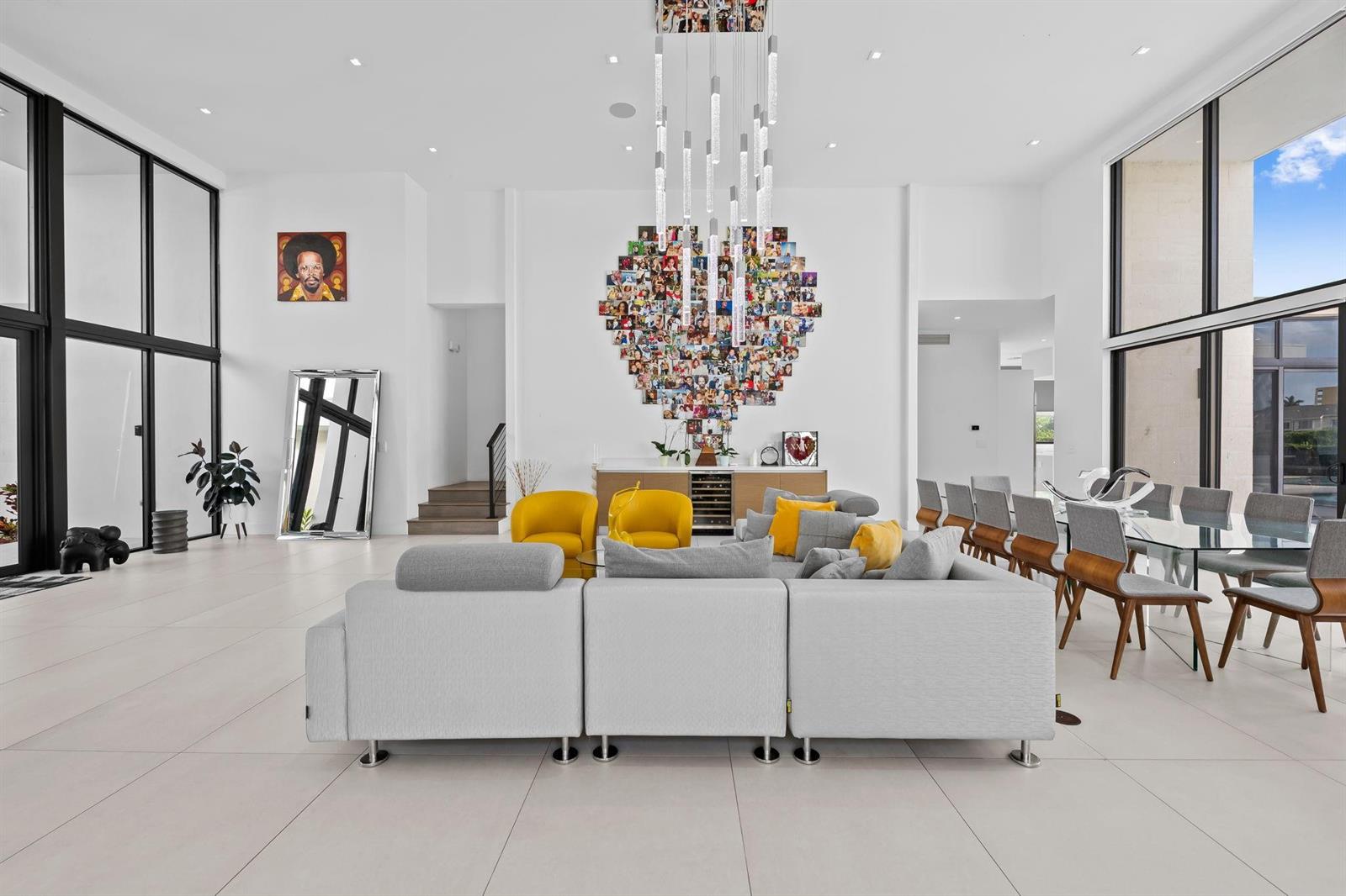 A modern, open-concept living and dining area features white tile floors and a heart-shaped photo collage — 16768 Natures Way, Weston FL 33326, WESTON, FL