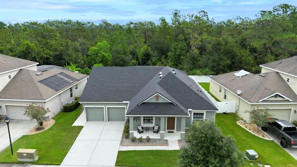 An aerial view shows a single-story house with a two-car garage and a shingled roof — 2651 MARSHFIELD PRESERVE WAY, KISSIMMEE, FL
