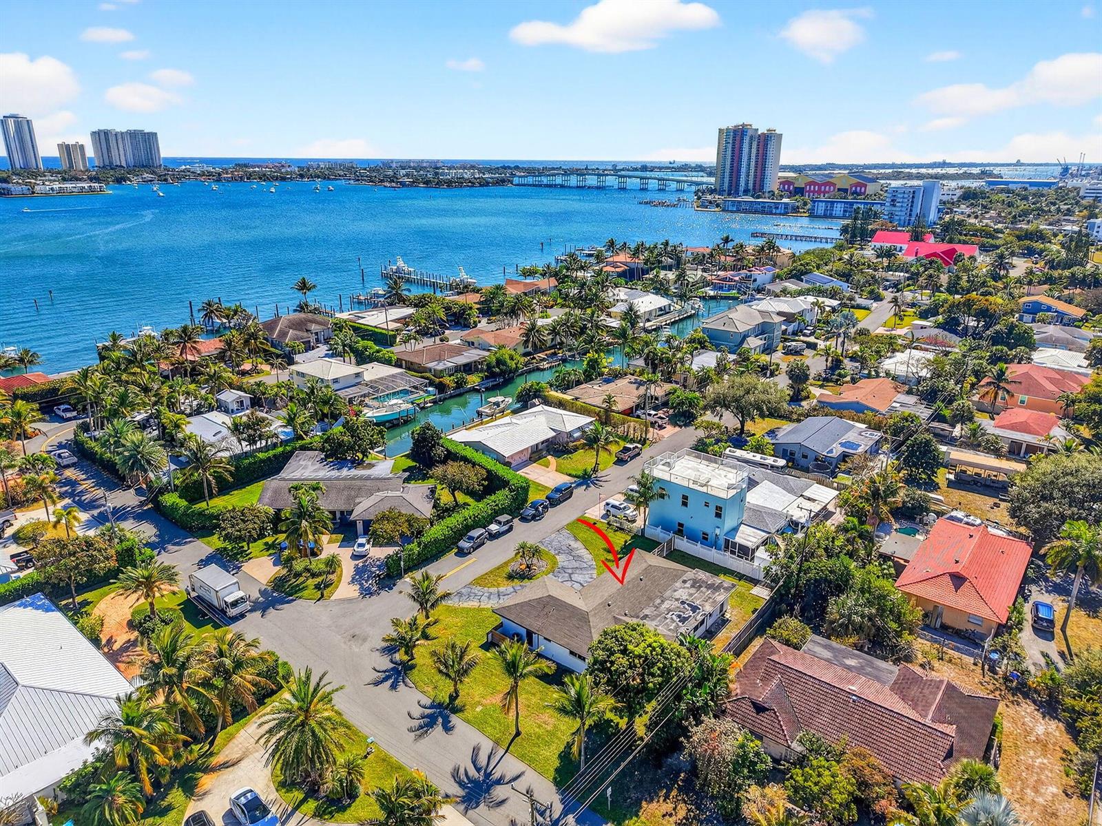 An aerial view shows a residential neighborhood with a house marked by a red arrow — 3651 Palm Drive, Riviera Beach FL 33404, RIVIERA BEACH, FL