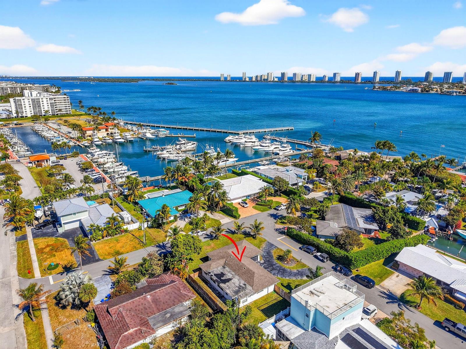 An aerial view shows a residential neighborhood near a marina and the ocean — 3651 Palm Drive, Riviera Beach FL 33404, RIVIERA BEACH, FL