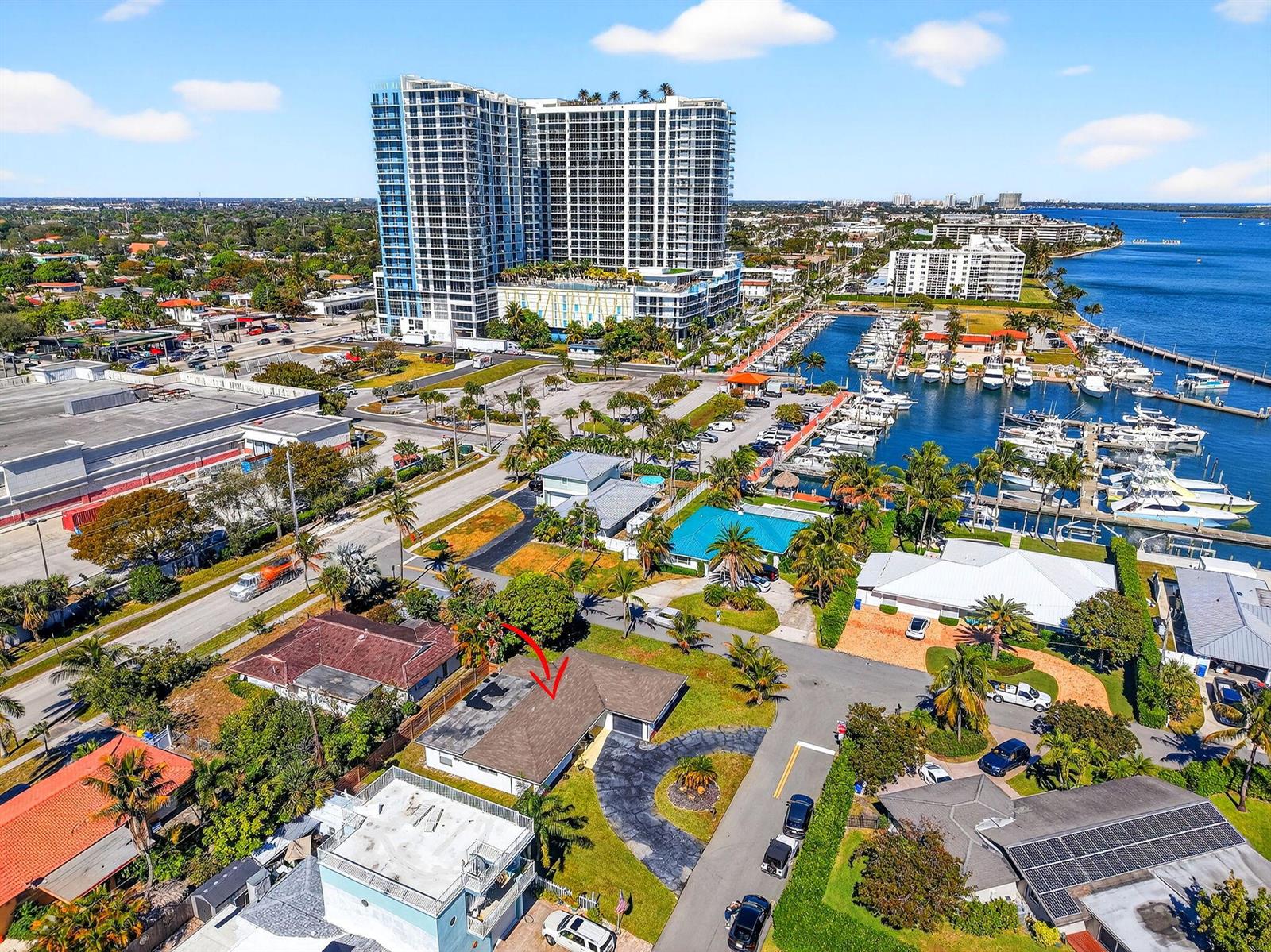 An aerial view shows a single-story house with a brown roof near a marina — 3651 Palm Drive, Riviera Beach FL 33404, RIVIERA BEACH, FL