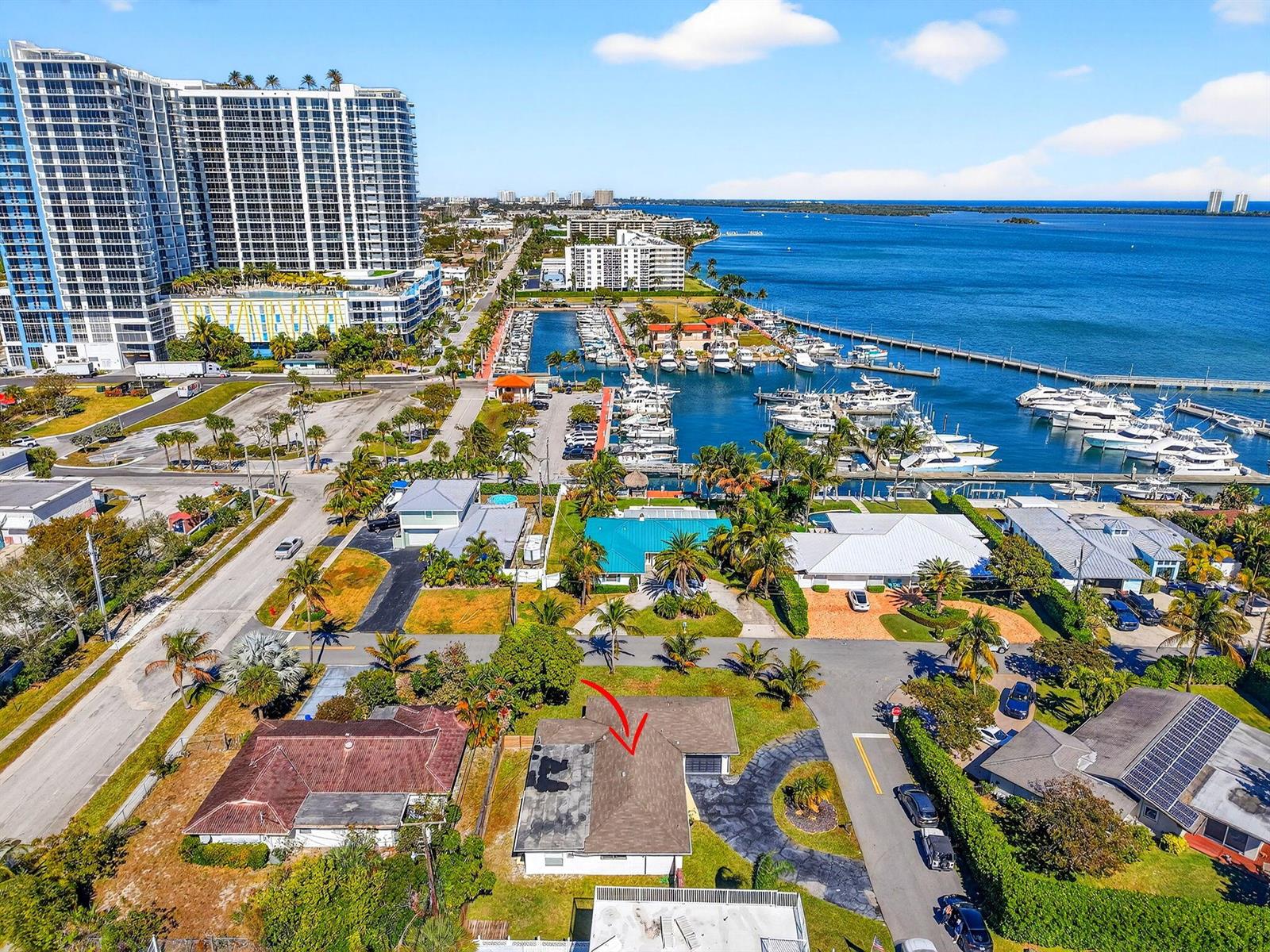 An aerial view shows a residential house with a red arrow pointing to its roof — 3651 Palm Drive, Riviera Beach FL 33404, RIVIERA BEACH, FL