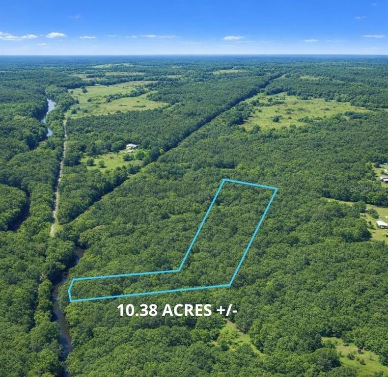 An aerial view shows a wooded plot of land outlined in blue — 0 CHEROKEE DRIVE, SOPCHOPPY, FL