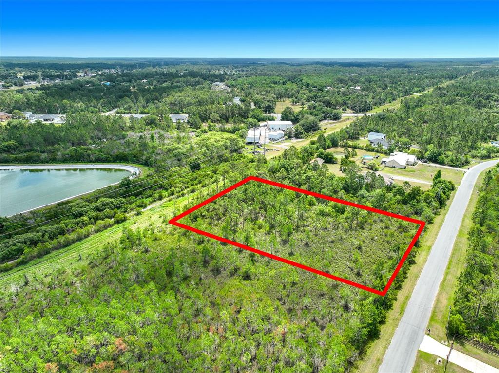 An aerial view shows a rectangular plot of land outlined in red beside a road — 00 WEMBLEY AVENUE, ORLANDO, FL