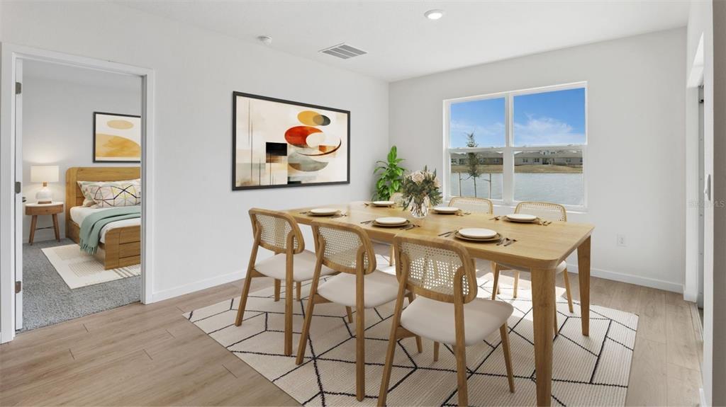 A dining room with a wooden table and chairs sits on a geometric area rug — 1012 CHAMPION RDG DRIVE, DAYTONA BEACH, FL