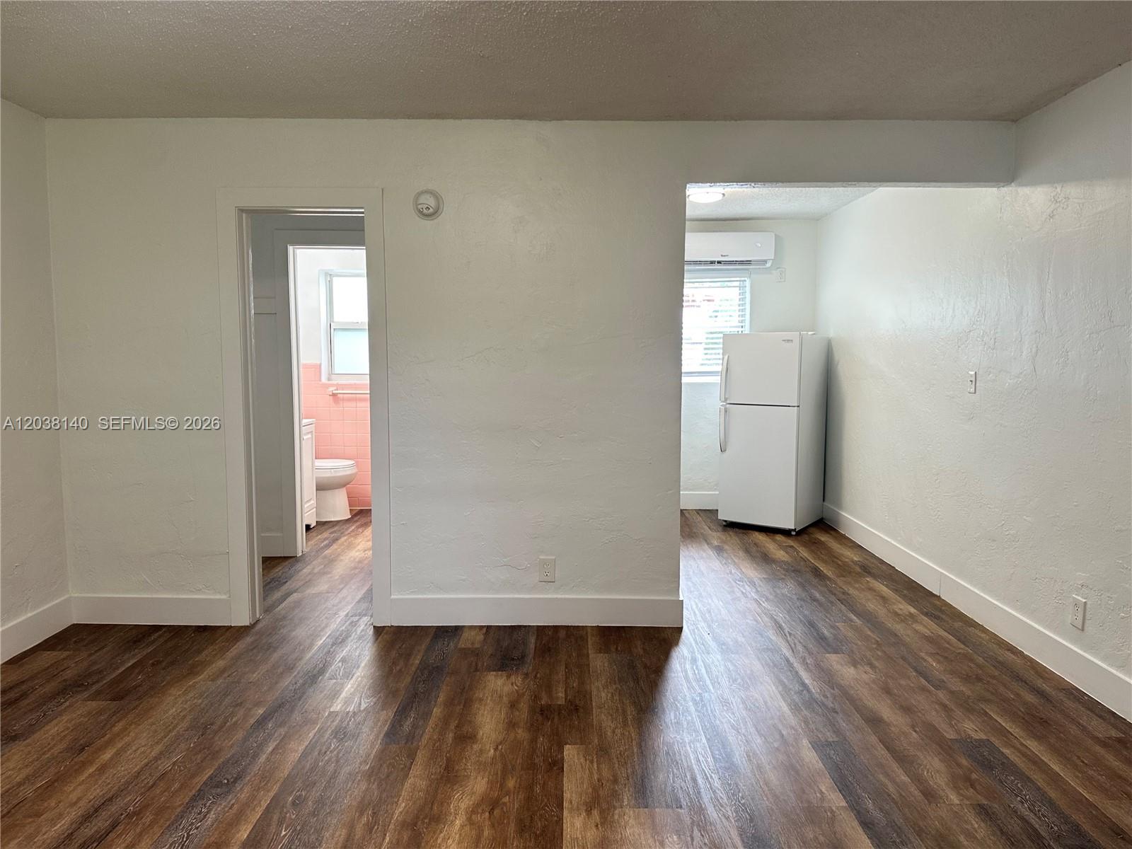 A kitchen features white cabinets, a stainless steel sink, and a white electric stove — 1821 Thomas St # 2, Hollywood FL 33020, HOLLYWOOD, FL