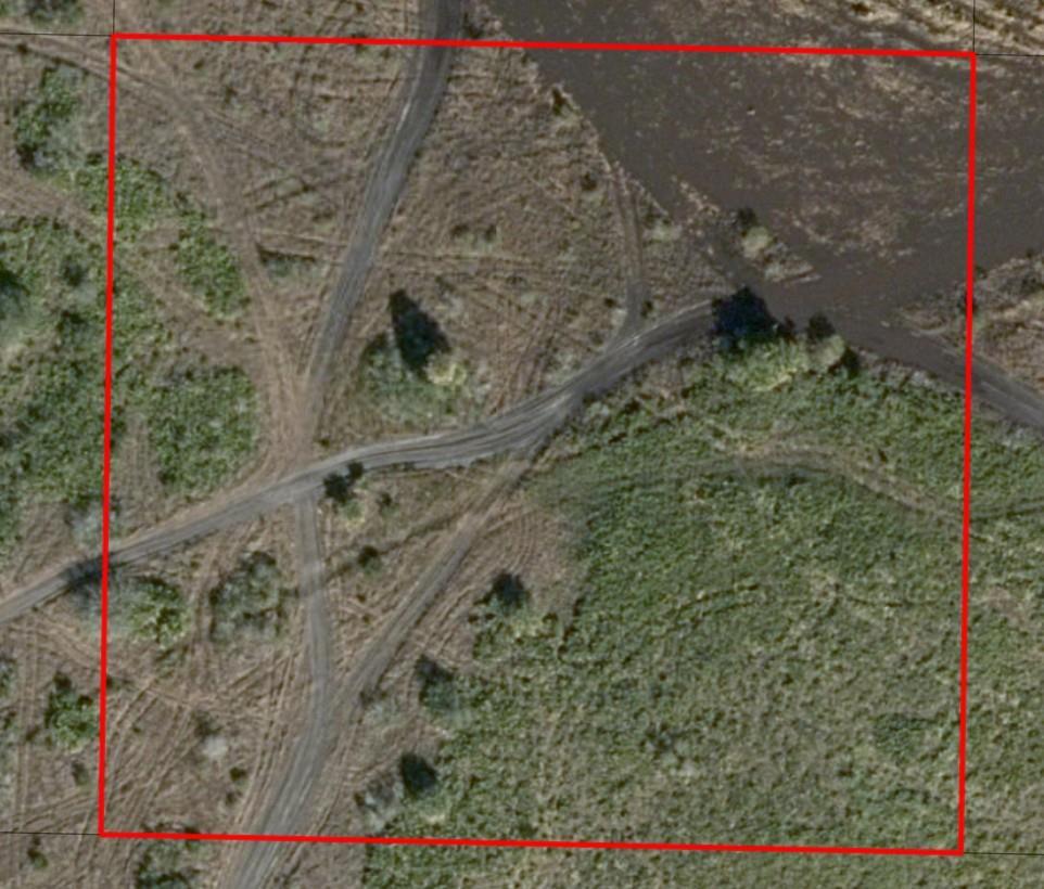 This aerial view shows a plot of land with dirt paths and a water feature — 0 NW 314th Street, Okeechobee FL 34972, OKEECHOBEE, FL