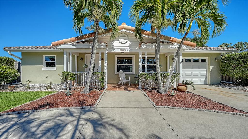A single-story house with a light green exterior, a front porch, and two palm trees — 3507 PINECREST STREET, SARASOTA, FL