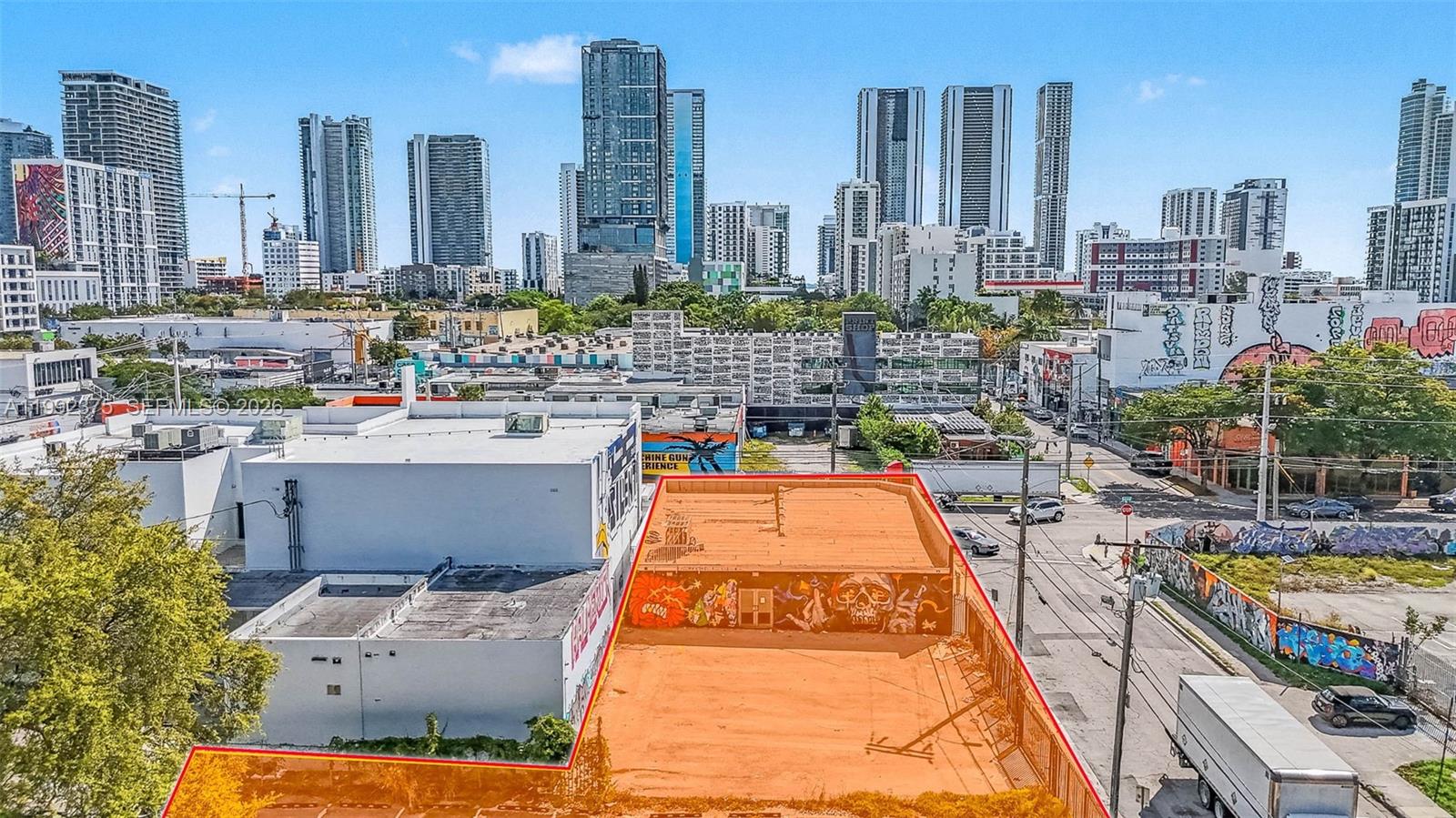 An aerial view shows a rectangular lot with a graffiti-covered building in an urban area — 2500 N Miami Ave, Miami FL 33127, MIAMI, FL