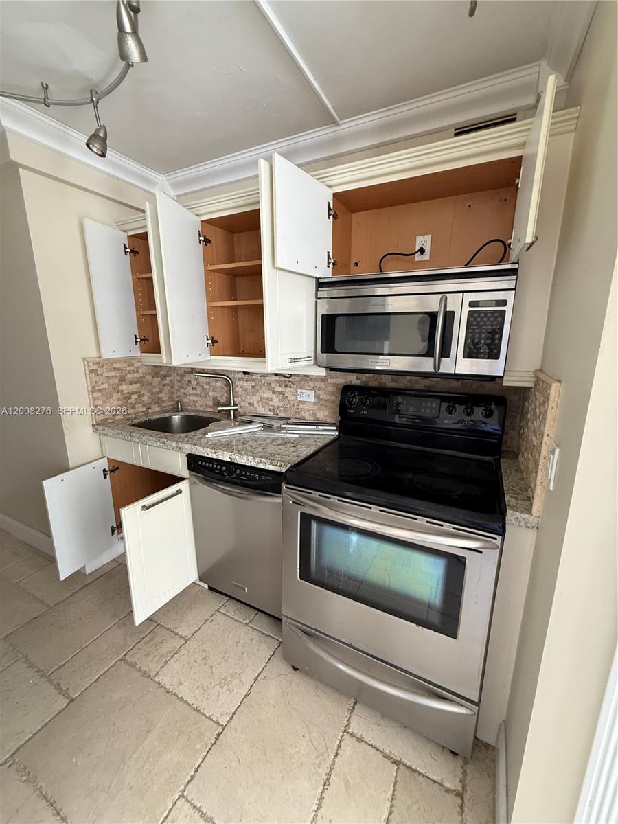 An empty room features light-colored stone tile flooring, a sliding glass door, and a balcony — 5313 Collins Ave # 801, Miami Beach FL 33140, MIAMI BEACH, FL
