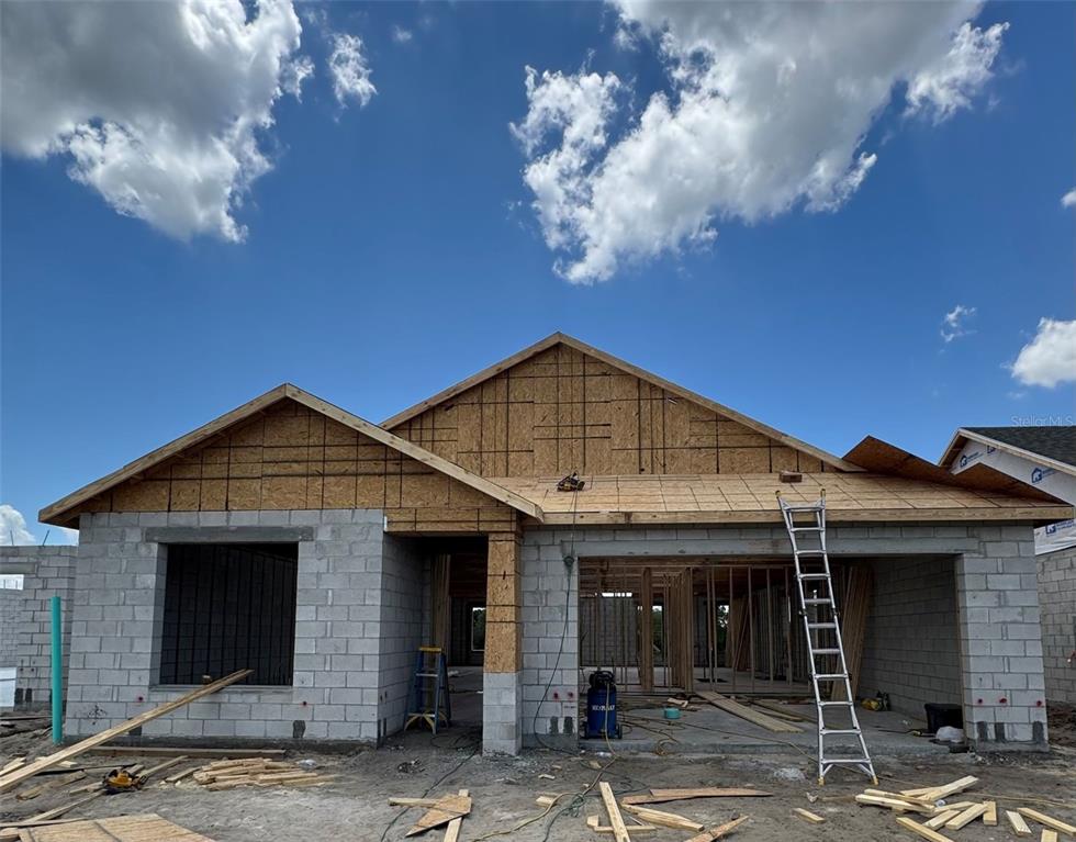 A single-story house under construction with concrete block walls and wooden roof framing — 30241 RUSTIC MILL STREET, MOUNT DORA, FL
