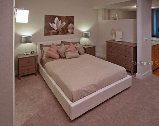 A bedroom features a white platform bed, two wooden nightstands, and a matching dresser — 1208 E KENNEDY BOULEVARD UNIT 1120, TAMPA, FL