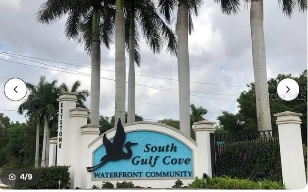The entrance sign for South Gulf Cove Waterfront Community features a heron silhouette and palm trees — 8198 DITMAR STREET, PORT CHARLOTTE, FL