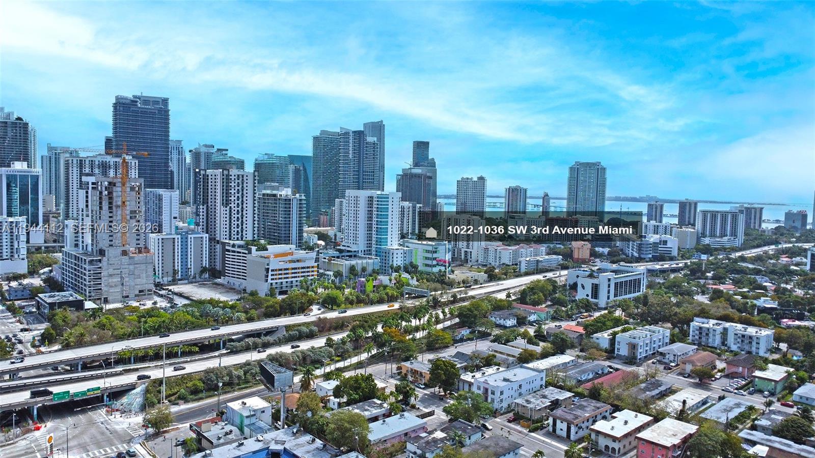 An aerial view shows a dense urban skyline with high-rise buildings and a highway — 1036 SW 3rd Ave, Miami FL 33130, MIAMI, FL