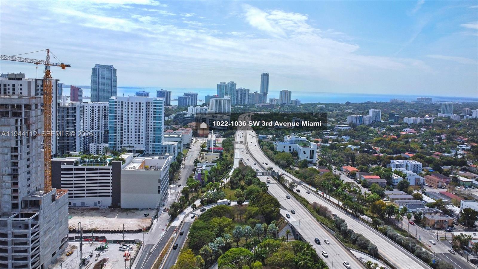 An aerial view shows a city skyline, a highway, and a construction site — 1036 SW 3rd Ave, Miami FL 33130, MIAMI, FL