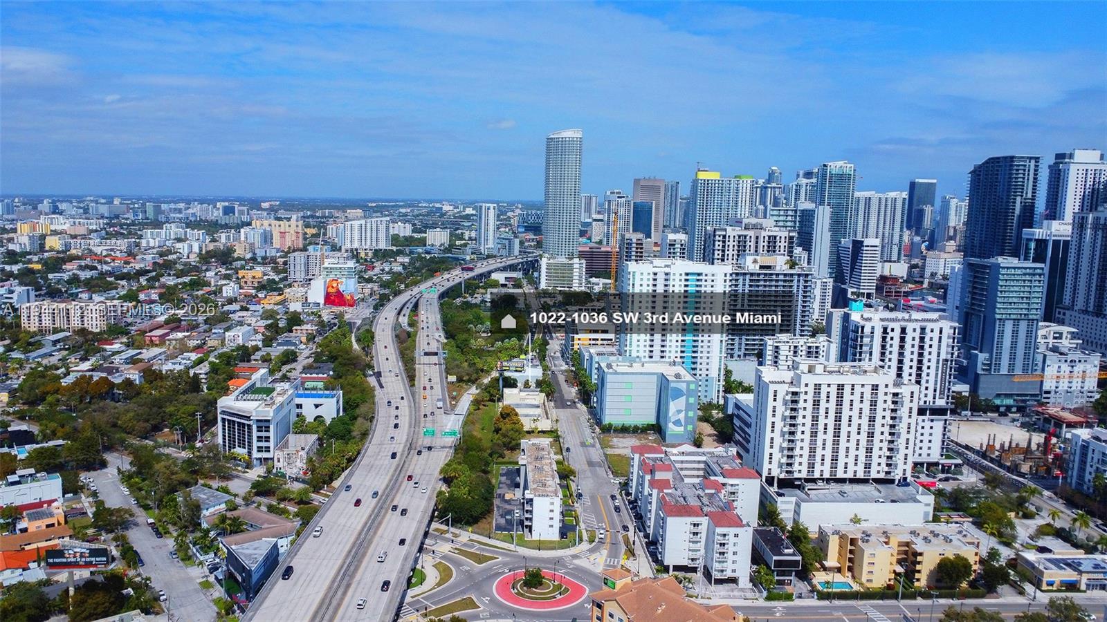 An aerial view shows a highway curving through a dense urban landscape with high-rise buildings — 1036 SW 3rd Ave, Miami FL 33130, MIAMI, FL