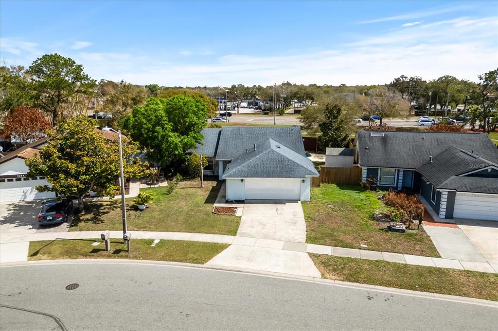 An aerial view shows a single-story house with a white garage and a gray roof — 2019 PAPRIKA DRIVE, ORLANDO, FL