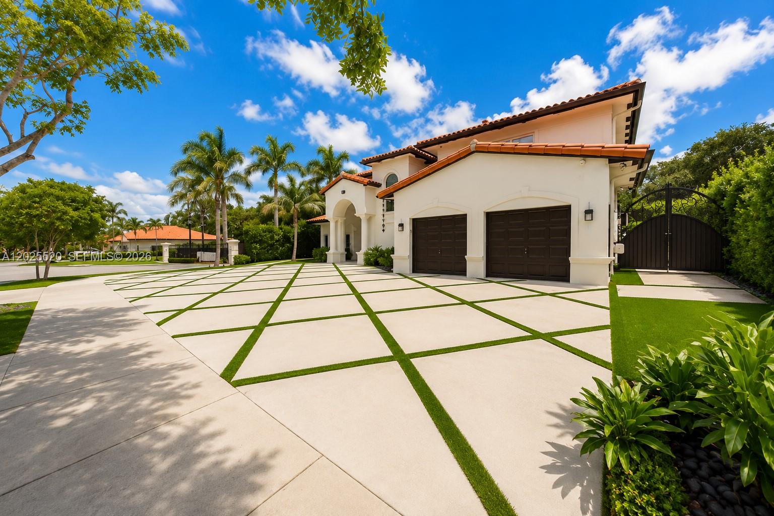 A white house with a tiled roof and a diamond-patterned concrete driveway with grass strips — 15721 NW 79th Ct, Miami Lakes FL 33016, MIAMI LAKES, FL