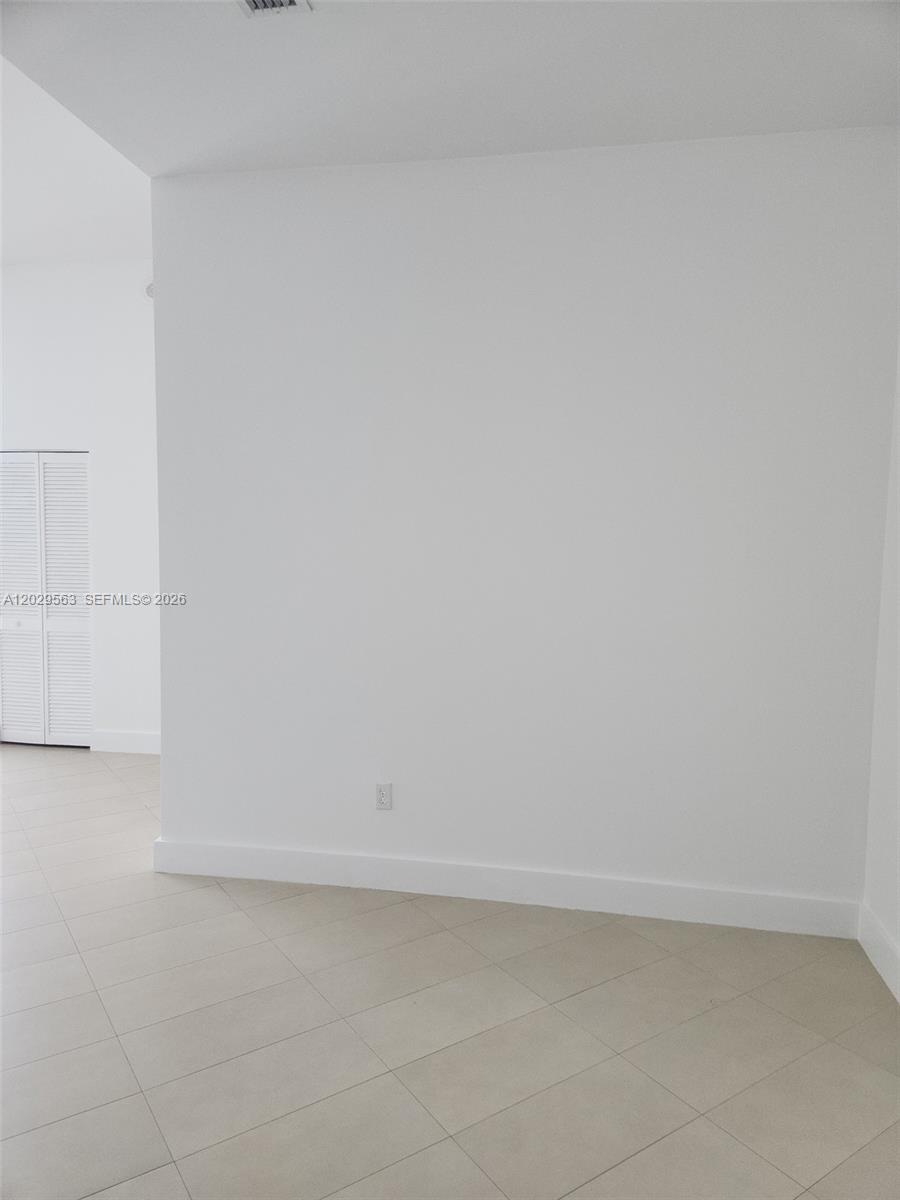 A plain white wall stands in a room with light-colored tile flooring — 300 S Biscayne Blvd # 3807, Miami FL 33131, MIAMI, FL