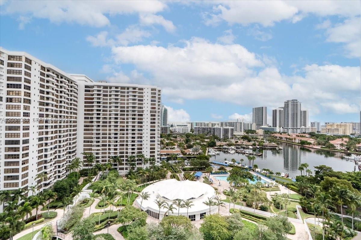 An elevated view of a high-rise apartment complex overlooking a marina and swimming pool — 600 Three Islands Blvd # 1413, Hallandale Beach FL 33009, HALLANDALE BEACH, FL