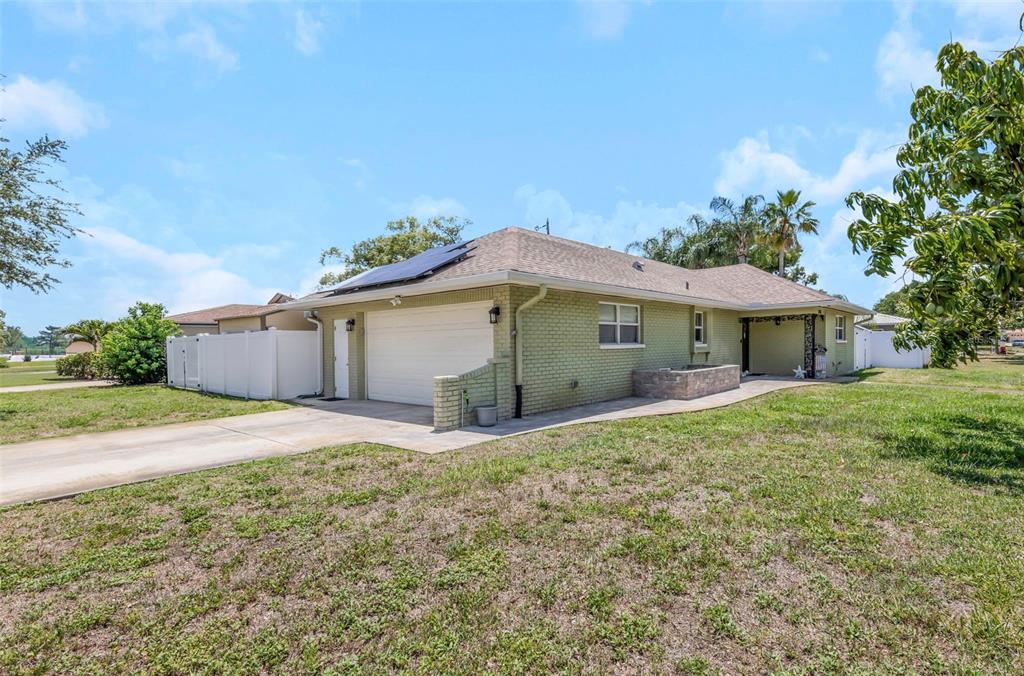 A single-story brick house with a two-car garage and solar panels on the roof — 2465 BURNICE DRIVE, CLEARWATER, FL