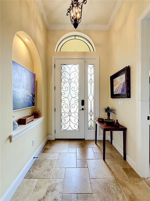 An entryway features a white door with decorative glass, a tiled floor, and an arched niche — 341 HIBISCUS WAY, PALM COAST, FL